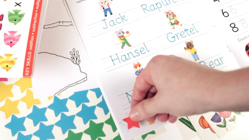 kids activity books with reward stickers being added